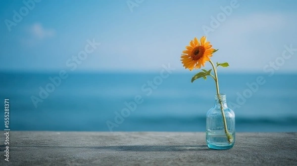 Obraz Minimalist Sunflower in Glass Vase by the Sea Under Soft Morning Light