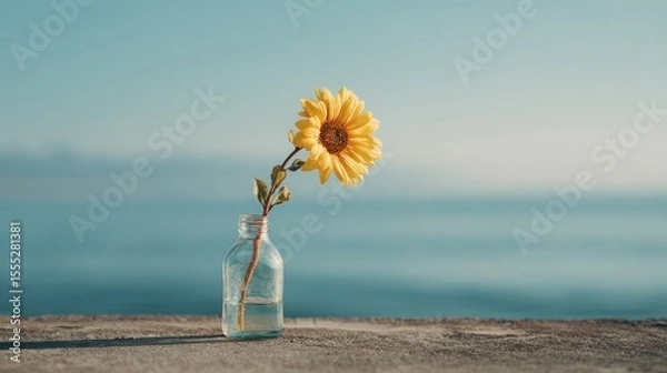 Obraz Minimalist Sunflower in Glass Vase by the Sea Under Soft Morning Light