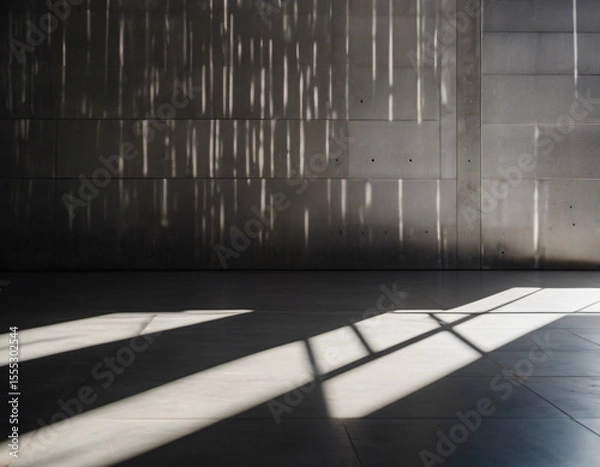 Fototapeta Parallel sunlight beams casting distinct patterns on a gray concrete wall and floor
