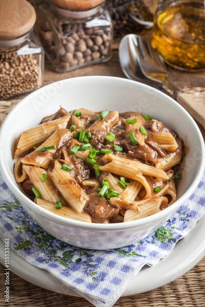 Fototapeta Pasta penne with pork sauce.
