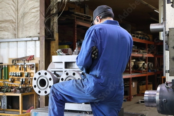 Obraz industrial worker operating a machine