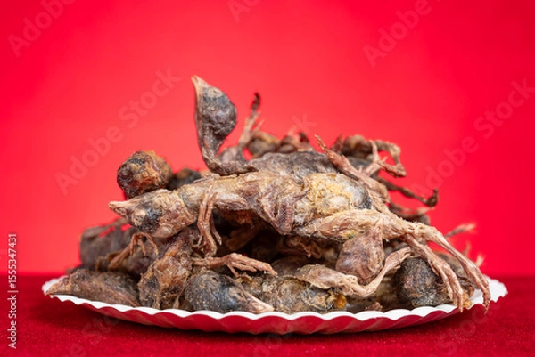 Obraz dish of freeze-dried quails at cats treats on a red background