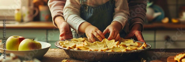 Obraz Child decorating apple pie with parent in a warm, cozy autumn kitchen