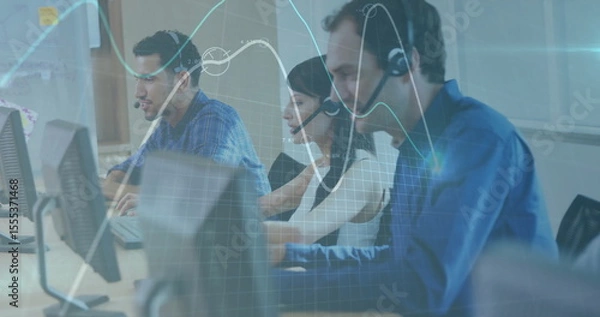 Obraz Handling customer calls using headsets and monitors while analyzing data overlays in open office