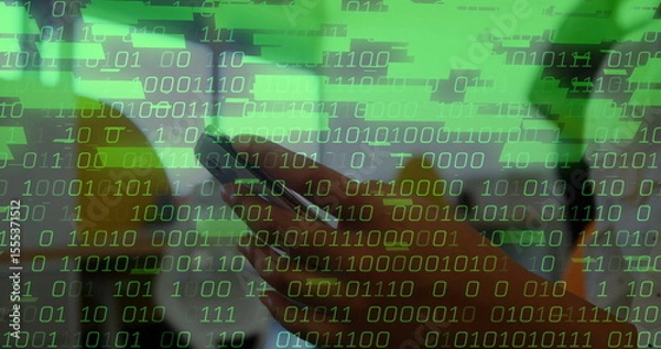 Obraz Holding smartphone with adult hand showing binary code overlay at home office, with potted plant