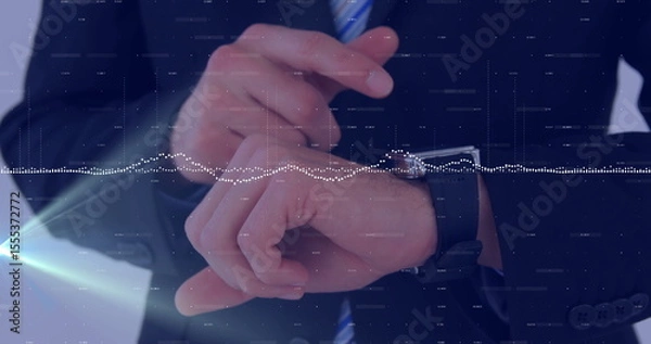 Obraz Business professional adjusting smartwatch on wrist in modern office, with digital waveform overlay