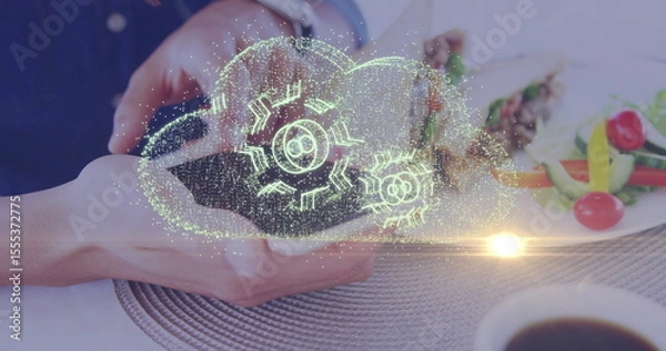 Obraz Holding smartphone projecting holographic cloud above dining table, with skewers and coffee cup