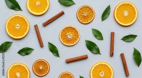 Obraz Flat lay of orange slices, cinnamon sticks and green leaves on a light backdrop