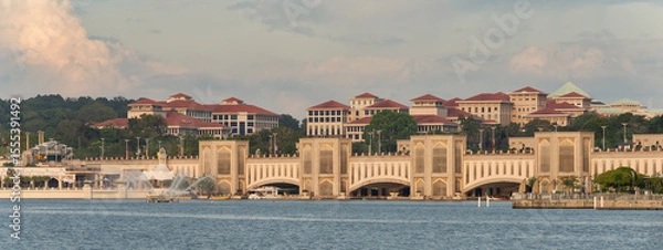 Fototapeta Putrajaya, Malaysia - Feb. 20, 2025: Panoramic view of Seri Gemilang Bridge and government buildings across Putrajaya Lake