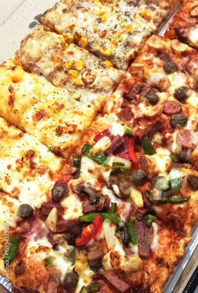 Fototapeta Assorted Pizza Slices in a Box
