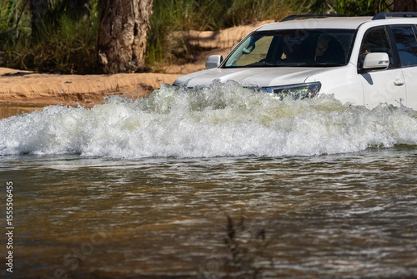 Fototapeta 4x4 vehicle driving through or across riveron expedition in Western Australian outback