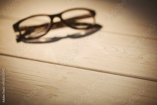 Obraz Black colored eyeglasses on table