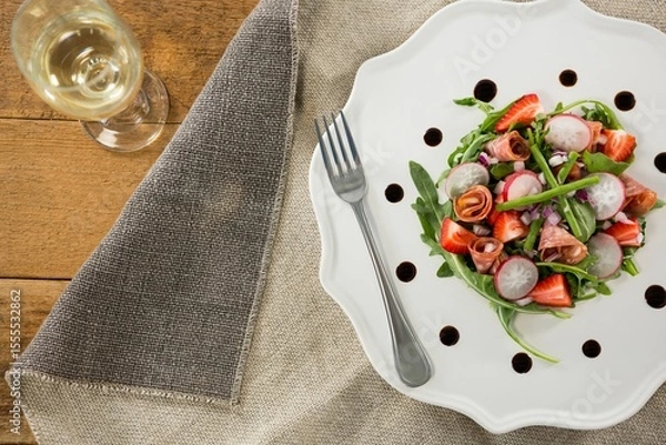 Fototapeta Fresh food with wine served on wooden table