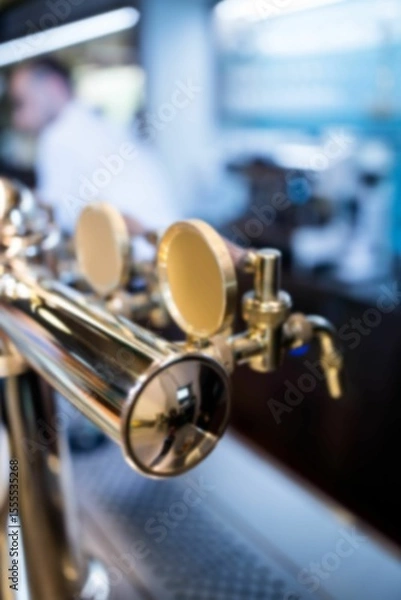 Fototapeta Brass beer tap tower is reflecting blue glow in 3D render with drip tray, blurred bartender