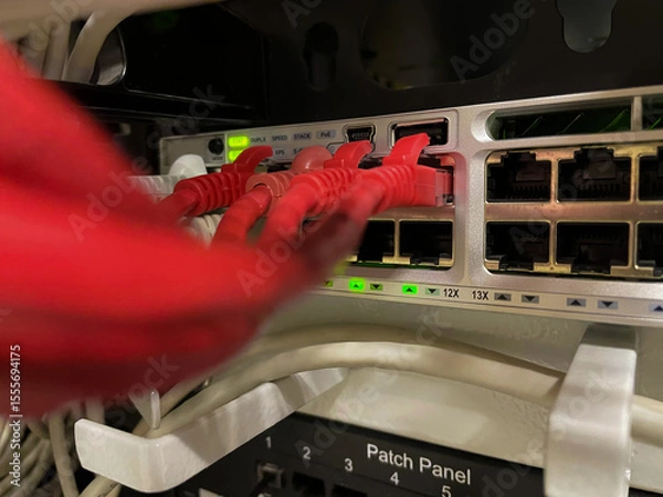 Fototapeta Several network wires connect to switching hub. Utp wires are in the office router close-up. Ethernet cables connected to the switch. Blurred foreground, focus on background