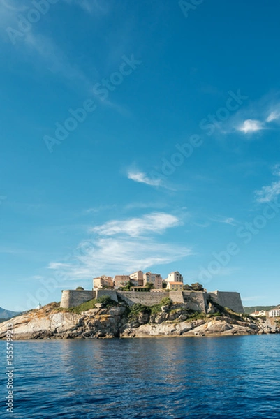 Fototapeta The medieval citadel of Calvi on the west coast of the Mediterranean island of Corsica with blue sky above