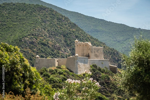 Fototapeta The recently renovated Genoese tower and fortress at Girolata, a small fishing village on the west coast of the mediteranean island of Corsica, only reached by foot or by boat