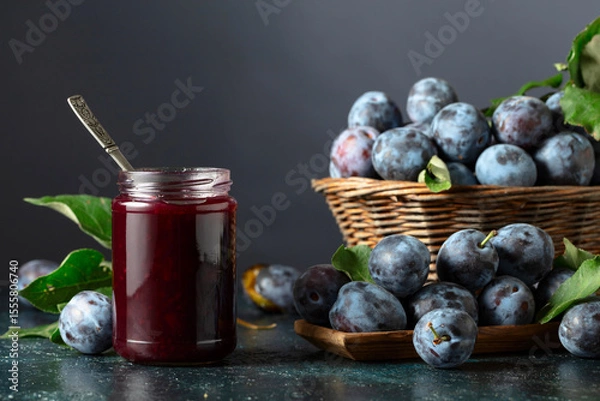 Obraz Ripe plums with jam on the kitchen table.