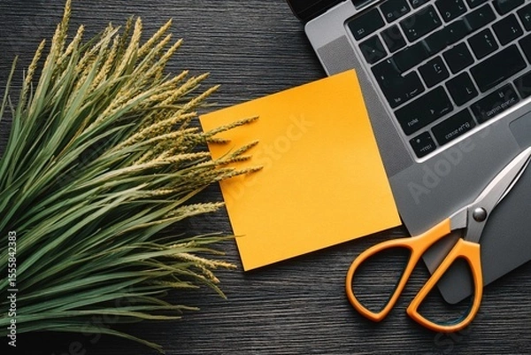 Fototapeta Creative workspace with scissors and sticky note beside a laptop and decorative plant
