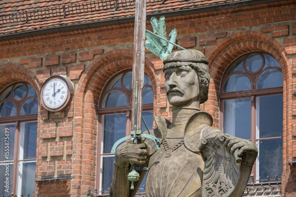 Fototapeta Stendal Roland statue stands in front of historic town hall in market square from 1525