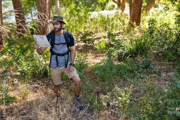Fototapeta Man reading the map in the forest