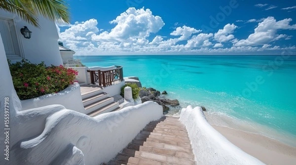 Fototapeta White Sand Steps Leading to a Turquoise Ocean Under a Bright Blue Sky with Fluffy Clouds