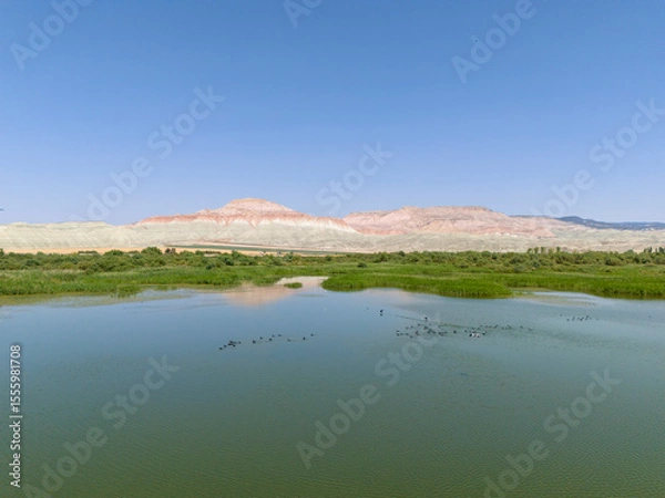Fototapeta Ankara Nallihan Bird Sanctuary Serene landscape view of a calm river reflecting mountains. High-angle, expansive view of  calm river reflecting the surrounding mountains Beypazari Nallihan Kus Cenneti