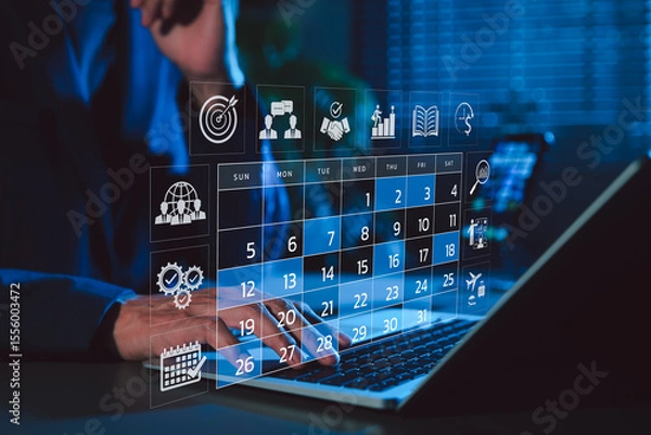 Obraz Time management and calendar planning concept. A person using laptop with digital monthly calendar, representing time management, event planning, appointment, agenda meeting, and schedule organization