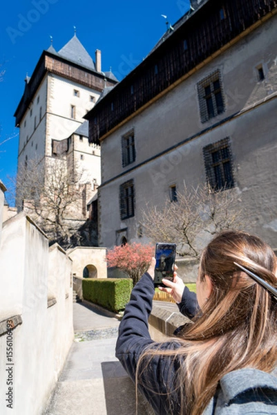 Obraz Mujer turista recorriendo el Castilo de Karlštejn en un día soleado y sin gente. Fotografía vertical