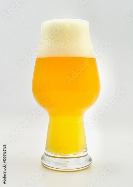 Obraz A glass of hazy IPA beer isolated against a white background. 