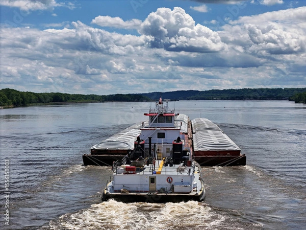 Obraz Rear view of a Tug boat pushing a large set of barges up the Mississippi River