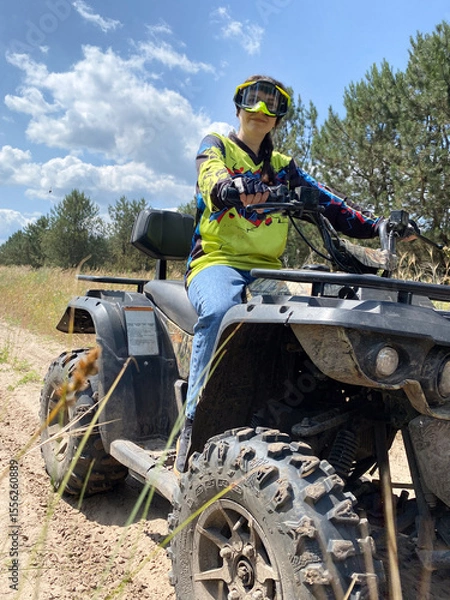 Fototapeta Quad bike ride on dirt roads in nature, vertical shooting