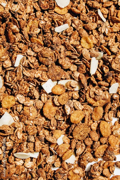 Obraz Crunchy granola mix with oats nuts and dried fruits in a bowl for breakfast or snack