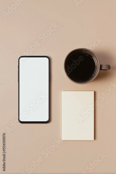 Fototapeta Minimalist flat lay of smartphone, coffee mug and notepad on neutral background