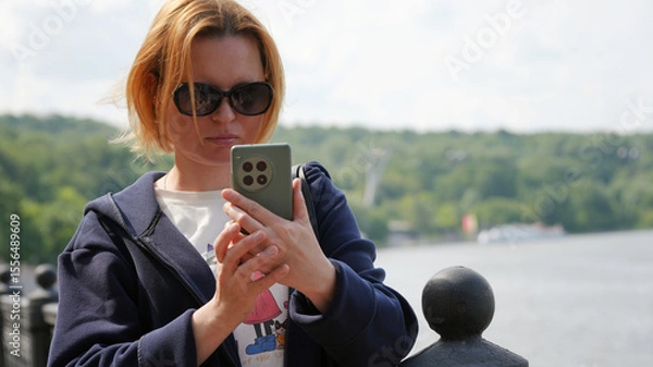 Fototapeta Close-up of a young woman with a phone11