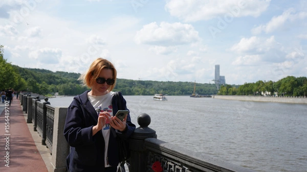 Fototapeta Close-up of a young woman with a phone13