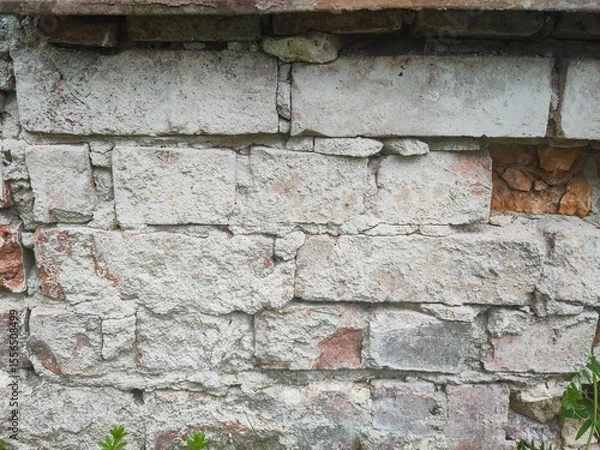Fototapeta Texture - Old deteriorated brick house facade
