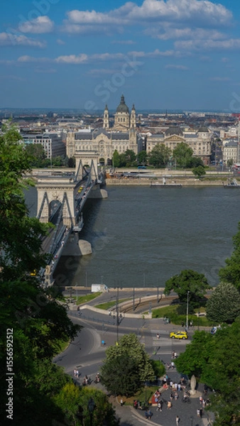 Fototapeta Aerial view of the Chain Bridge over the Danube River in Budapest with St. Stephen's Basilica and surrounding cityscape in the background.