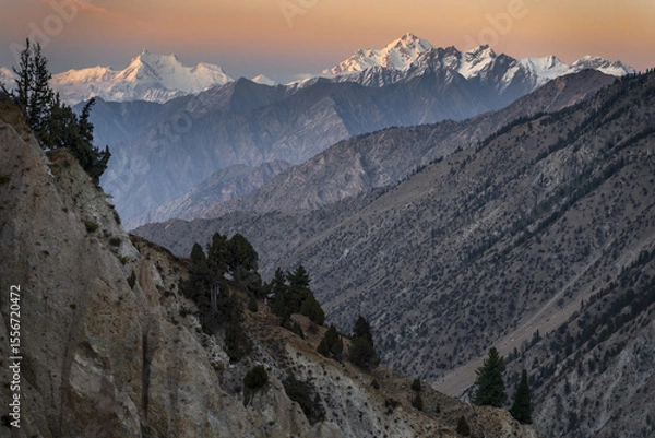 Obraz Snow-Capped Mountains Under a Warm Sunset Sky