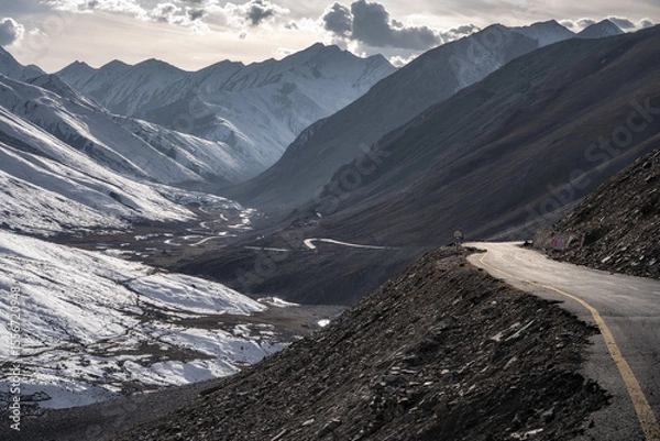 Obraz Mountain Road Winding Through a Snow-Dusted Valley