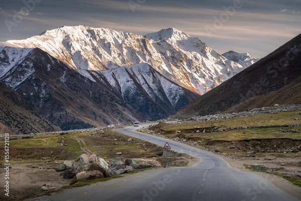Obraz Curving Road Leading to Snow-Capped Mountain Range