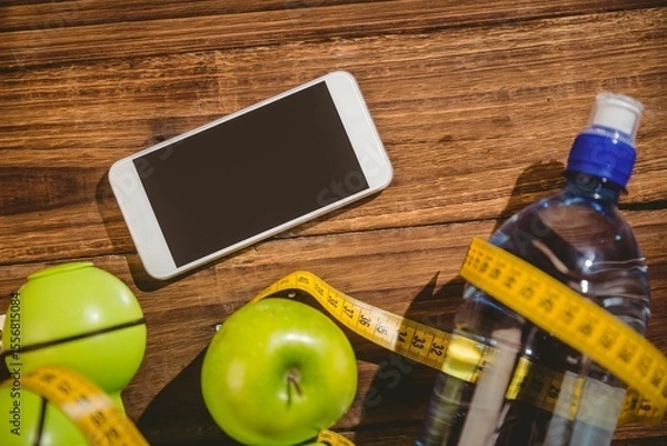 Obraz High angle view of apples and mobile phone on table