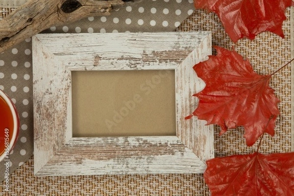 Fototapeta Photo frame and maple leaf on wooden table