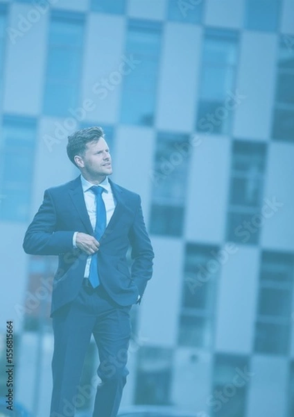 Obraz Businessman walking against building