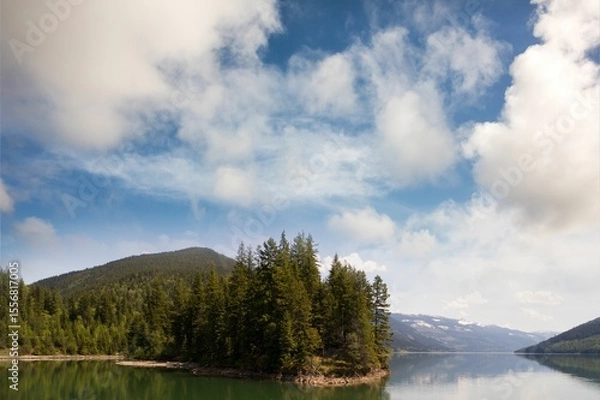 Obraz Trees growing by lake and mountains against sky