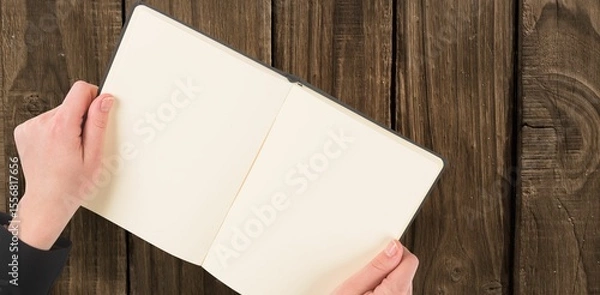 Obraz Overhead view of hand holding book