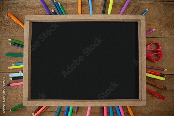 Fototapeta High angle view of empty chalkboard with colorful equipment