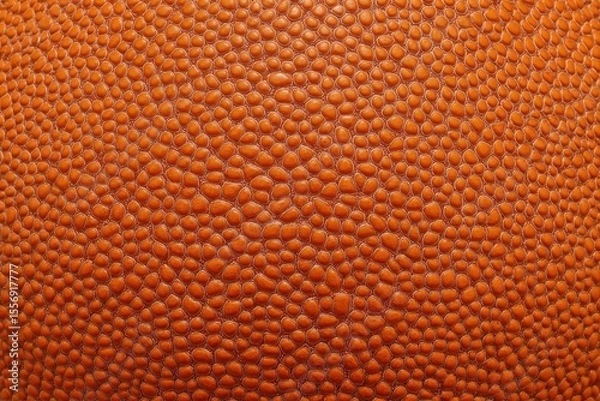 Fototapeta Close-up view of an orange basketball texture showcasing intricate details and realism in its surface design against a plain background