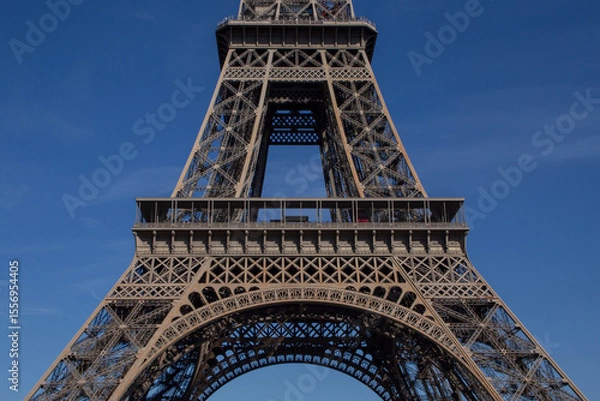 Fototapeta enter part of Eiffel 
Tower in Paris against blue sky