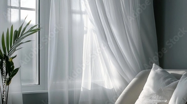 Fototapeta Bedroom with a large window on the left side. the window is covered with white sheer curtains that are open, allowing natural light to enter the room.